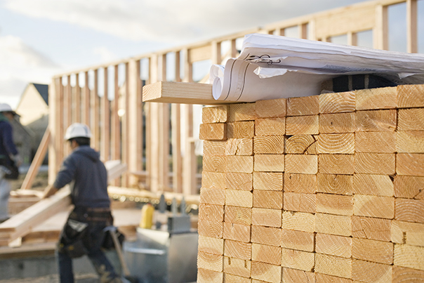 Stacked Lumber And Blueprints At A Construction Site