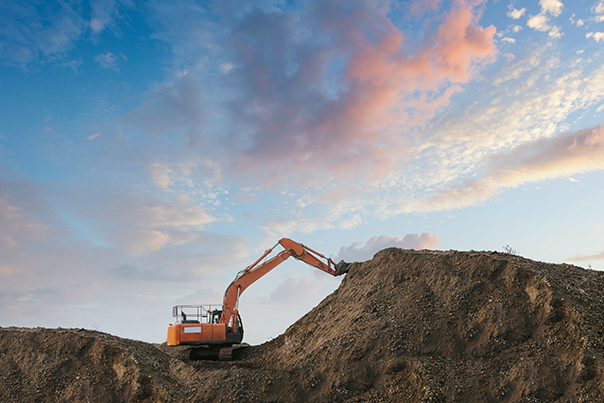 An Excavator Digging Up Dirt In A Sand Pit